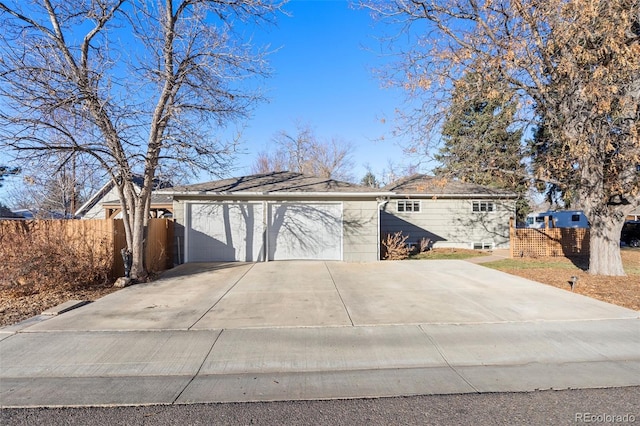 view of front of property with a garage and fence