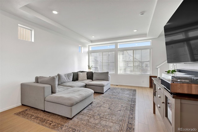 living area featuring recessed lighting, light wood finished floors, and baseboards