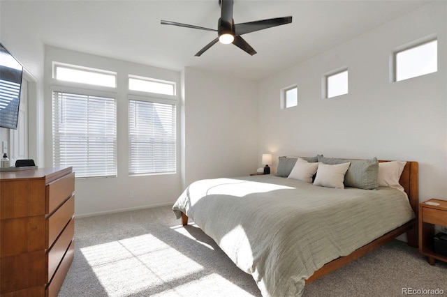 bedroom featuring baseboards, a ceiling fan, and light colored carpet