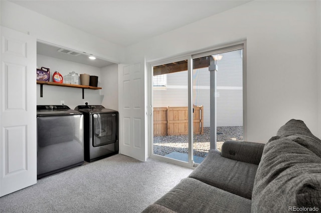 laundry room with carpet, indoor wet bar, visible vents, washing machine and dryer, and laundry area