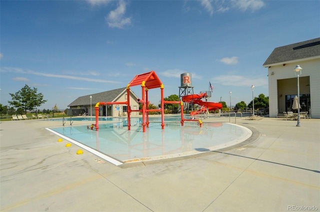 view of jungle gym featuring a water play area and a patio