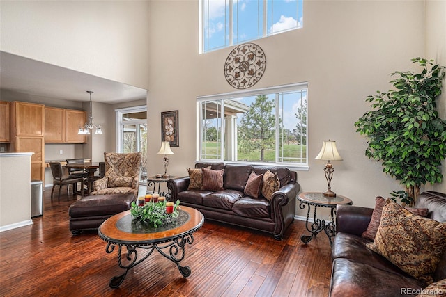 7004 S Addison Ct, Aurora, CO 80016 - living area with plenty of natural light, dark wood-style flooring, a high ceiling, and baseboards