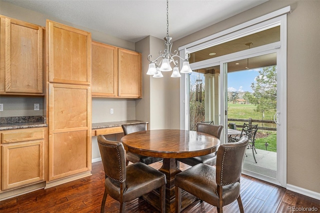 7004 S Addison Ct, Aurora, CO 80016 - dining area featuring dark wood-style floors, baseboards, and a chandelier