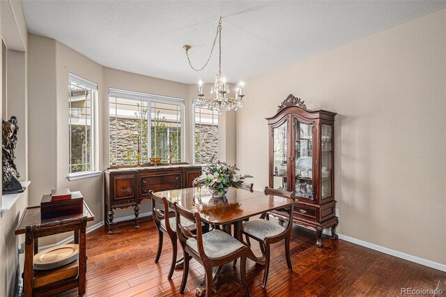 7004 S Addison Ct, Aurora, CO 80016 - dining room with a chandelier, hardwood / wood-style floors, and baseboards