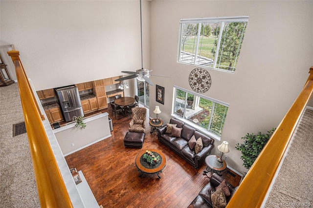 7004 S Addison Ct, Aurora, CO 80016 - living area featuring a high ceiling, a ceiling fan, hardwood / wood-style floors, and stairs