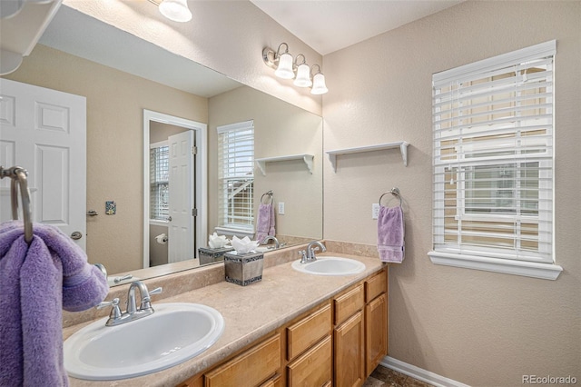 7004 S Addison Ct, Aurora, CO 80016 - bathroom featuring double vanity and a textured wall