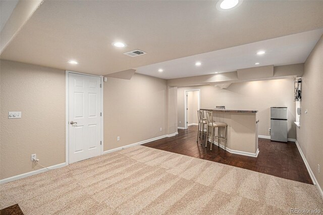 7004 S Addison Ct, Aurora, CO 80016 - indoor bar with dark colored carpet, freestanding refrigerator, baseboards, recessed lighting, and dark wood-style floors