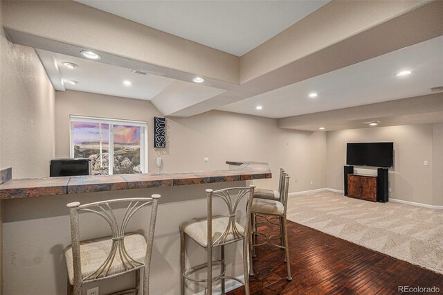 7004 S Addison Ct, Aurora, CO 80016 - indoor wet bar with carpet floors, wood finished floors, recessed lighting, and baseboards