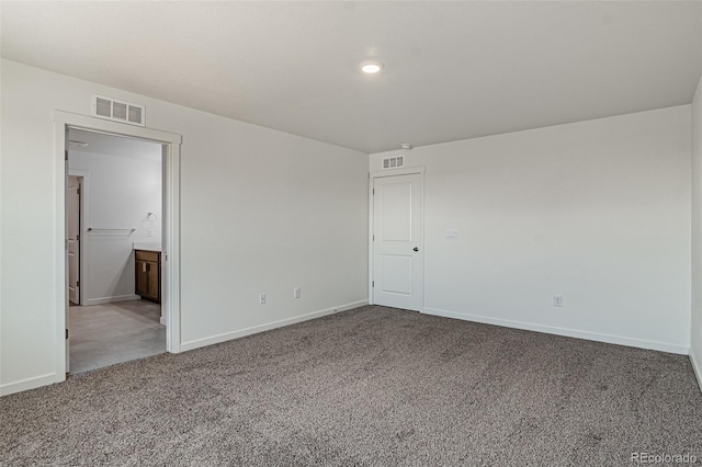 unfurnished bedroom with carpet flooring, visible vents, and baseboards