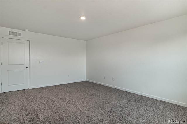 carpeted spare room featuring baseboards, recessed lighting, and visible vents
