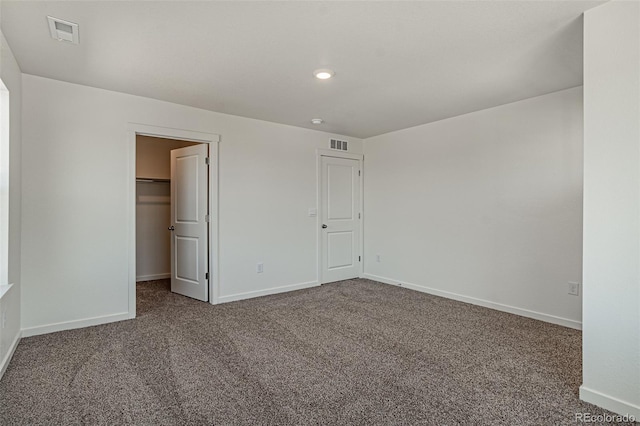 unfurnished bedroom featuring baseboards, visible vents, and carpet floors