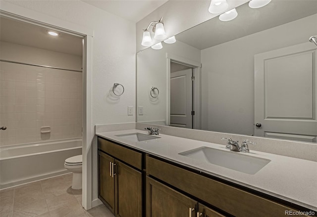 bathroom with a sink, double vanity, toilet, and shower / washtub combination