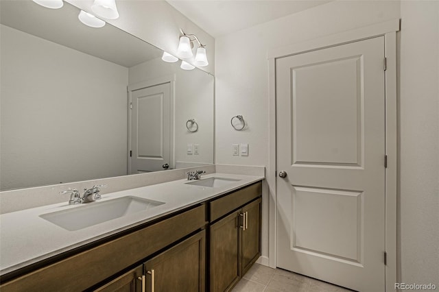 bathroom featuring tile patterned floors, double vanity, and a sink