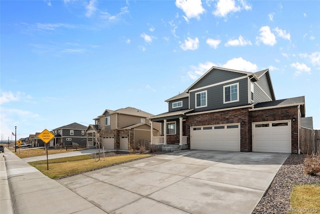 craftsman-style home with fence, an attached garage, brick siding, a residential view, and driveway