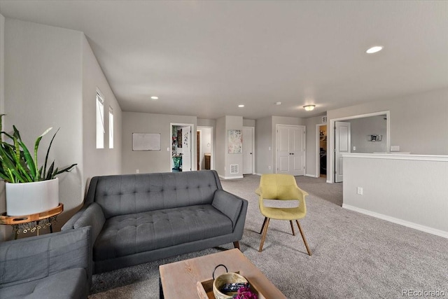 carpeted living room featuring baseboards and recessed lighting