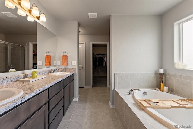 full bath with a stall shower, visible vents, a sink, tile patterned floors, and a garden tub