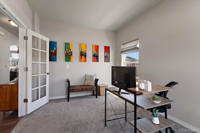 carpeted office space with french doors, baseboards, and arched walkways
