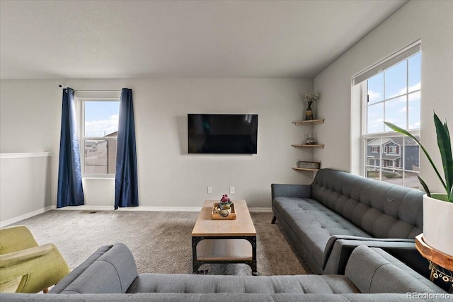 carpeted living area with a wealth of natural light and baseboards
