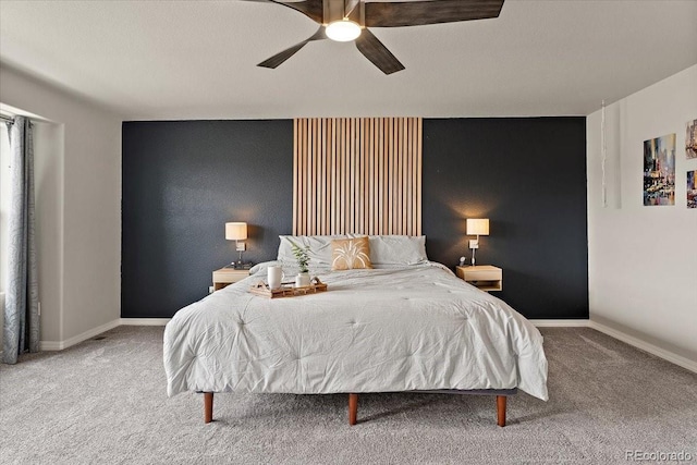 carpeted bedroom featuring baseboards and a ceiling fan
