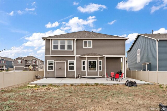 rear view of house featuring a patio and a fenced backyard