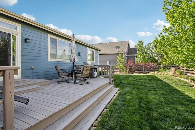 9139 Flora St, Arvada, CO 80005 - wooden terrace featuring a lawn, outdoor dining area, and area for grilling