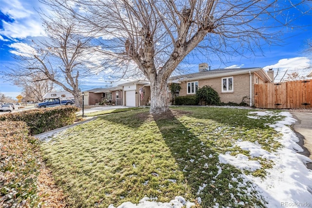 view of front of house with a garage and a front lawn