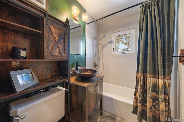 bathroom featuring shower / bath combination with curtain, toilet, and vanity