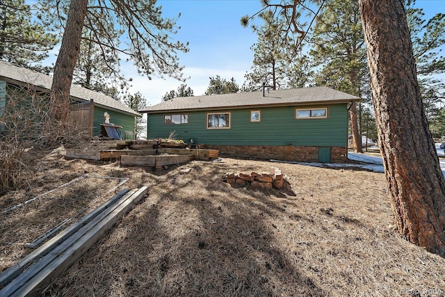 rear view of property with a vegetable garden