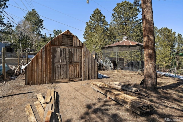 view of outbuilding featuring an outbuilding and fence