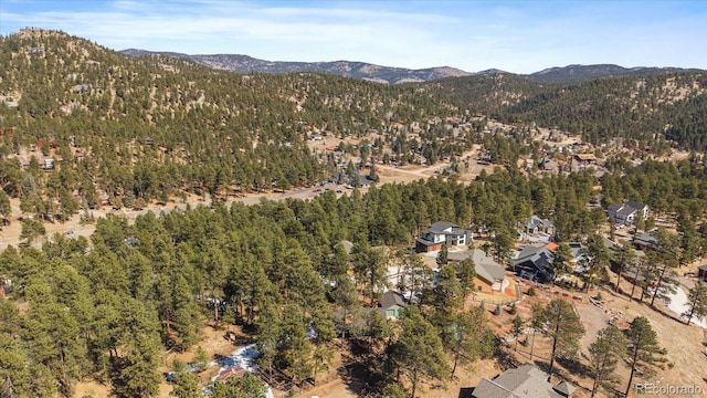 aerial view with a mountain view and a forest view