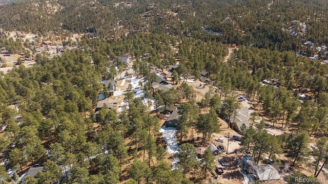 drone / aerial view with a wooded view