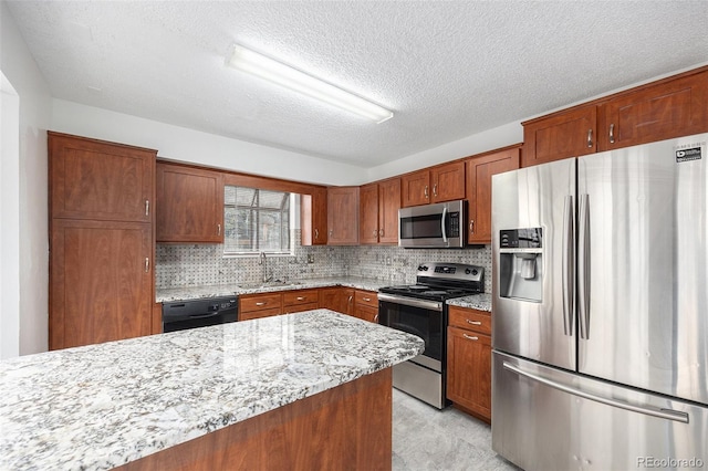14190 E Gunnison Pl, Aurora, CO 80012 - kitchen featuring appliances with stainless steel finishes, light stone counters, tasteful backsplash, a textured ceiling, and brown cabinetry