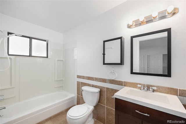 14190 E Gunnison Pl, Aurora, CO 80012 - full bathroom featuring vanity, tile walls, bathing tub / shower combination, wainscoting, and tile patterned flooring