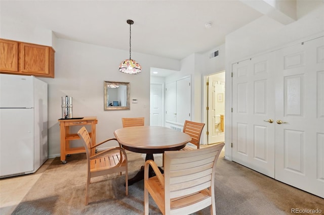 dining room featuring light carpet