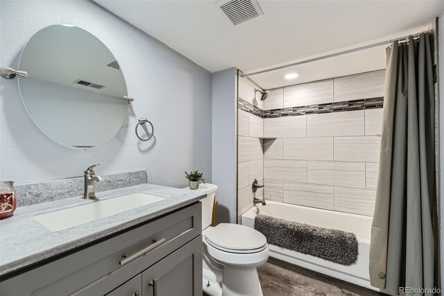 full bath featuring visible vents, toilet, shower / bathtub combination with curtain, and vanity