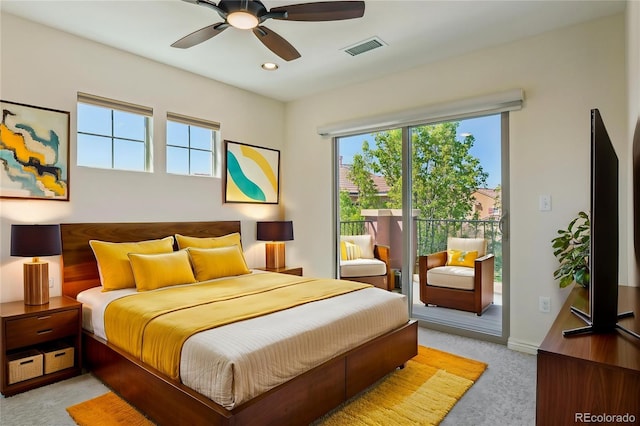 bedroom with light colored carpet, multiple windows, visible vents, and access to outside
