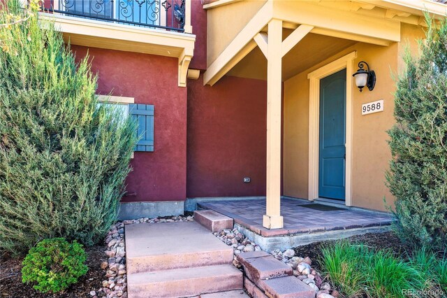 entrance to property featuring stucco siding