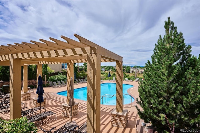 community pool with a patio and a pergola