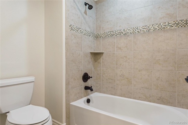 bathroom with toilet, baseboards, and bathing tub / shower combination