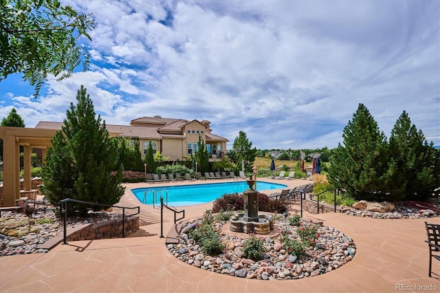 community pool featuring a patio area