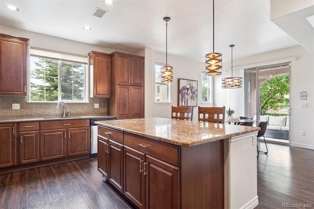 9588 Firenze Way, Highlands Ranch, CO 80126 - kitchen with dishwasher, dark wood-type flooring, a center island, backsplash, and recessed lighting