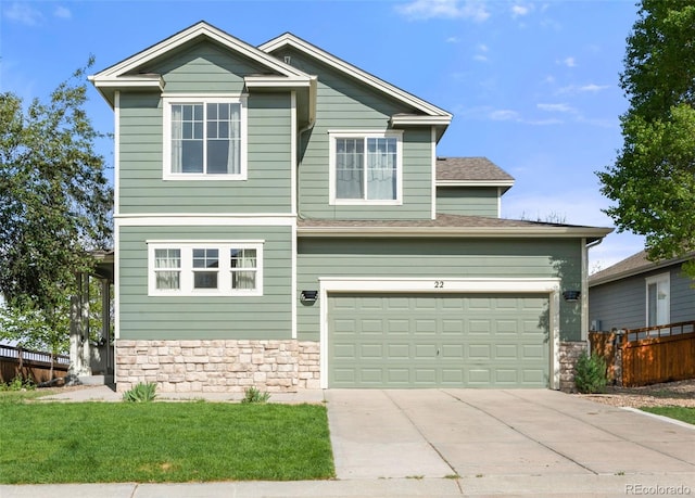 22 Apache Plume St, Brighton, CO 80601 - view of front facade featuring driveway, stone siding, fence, and an attached garage