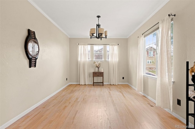 22 Apache Plume St, Brighton, CO 80601 - unfurnished dining area with a chandelier, wood finished floors, baseboards, and crown molding