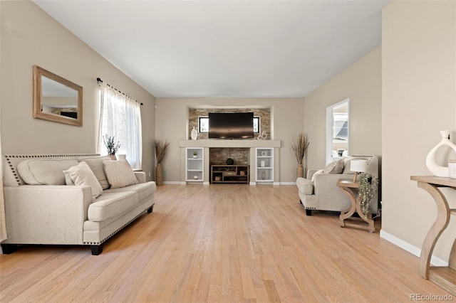 22 Apache Plume St, Brighton, CO 80601 - living area featuring wood finished floors, a fireplace, and baseboards