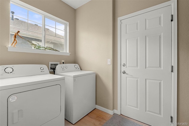 22 Apache Plume St, Brighton, CO 80601 - clothes washing area featuring separate washer and dryer, light wood-type flooring, and baseboards