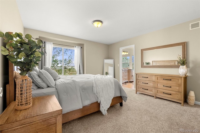 22 Apache Plume St, Brighton, CO 80601 - bedroom featuring light carpet, ensuite bathroom, and baseboards