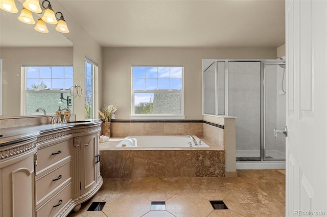 22 Apache Plume St, Brighton, CO 80601 - bathroom with a chandelier, vanity, a stall shower, and a bath