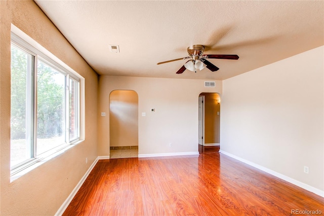 9150 Lilly Ct, Thornton, CO 80229 - unfurnished room featuring arched walkways, a ceiling fan, and light wood-style floors