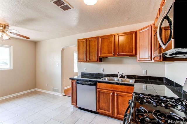 9150 Lilly Ct, Thornton, CO 80229 - kitchen featuring appliances with stainless steel finishes, arched walkways, ceiling fan, plenty of natural light, and a textured ceiling