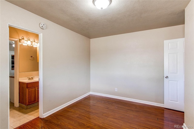 9150 Lilly Ct, Thornton, CO 80229 - unfurnished room with wood finished floors, a smoke detector, and a textured ceiling